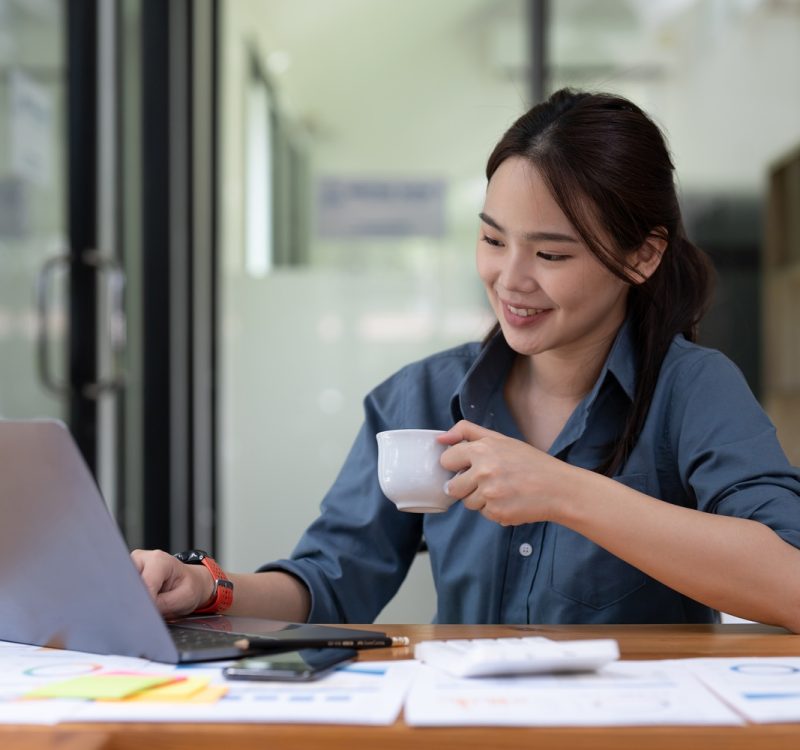 Young woman using laptop while working for business financial investment.
